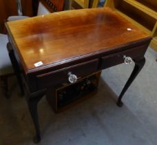 A MAHOGANY SIDE TABLE WITH TWO DRAWERS AND SHAPED TOP