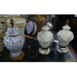 A PAIR OF COMPOSITE CREAM COLOURED TABLE LAMPS WITH EMBOSSED SWAGS DECORATION AND SHADES, A BLUE AND