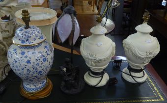 A PAIR OF COMPOSITE CREAM COLOURED TABLE LAMPS WITH EMBOSSED SWAGS DECORATION AND SHADES, A BLUE AND