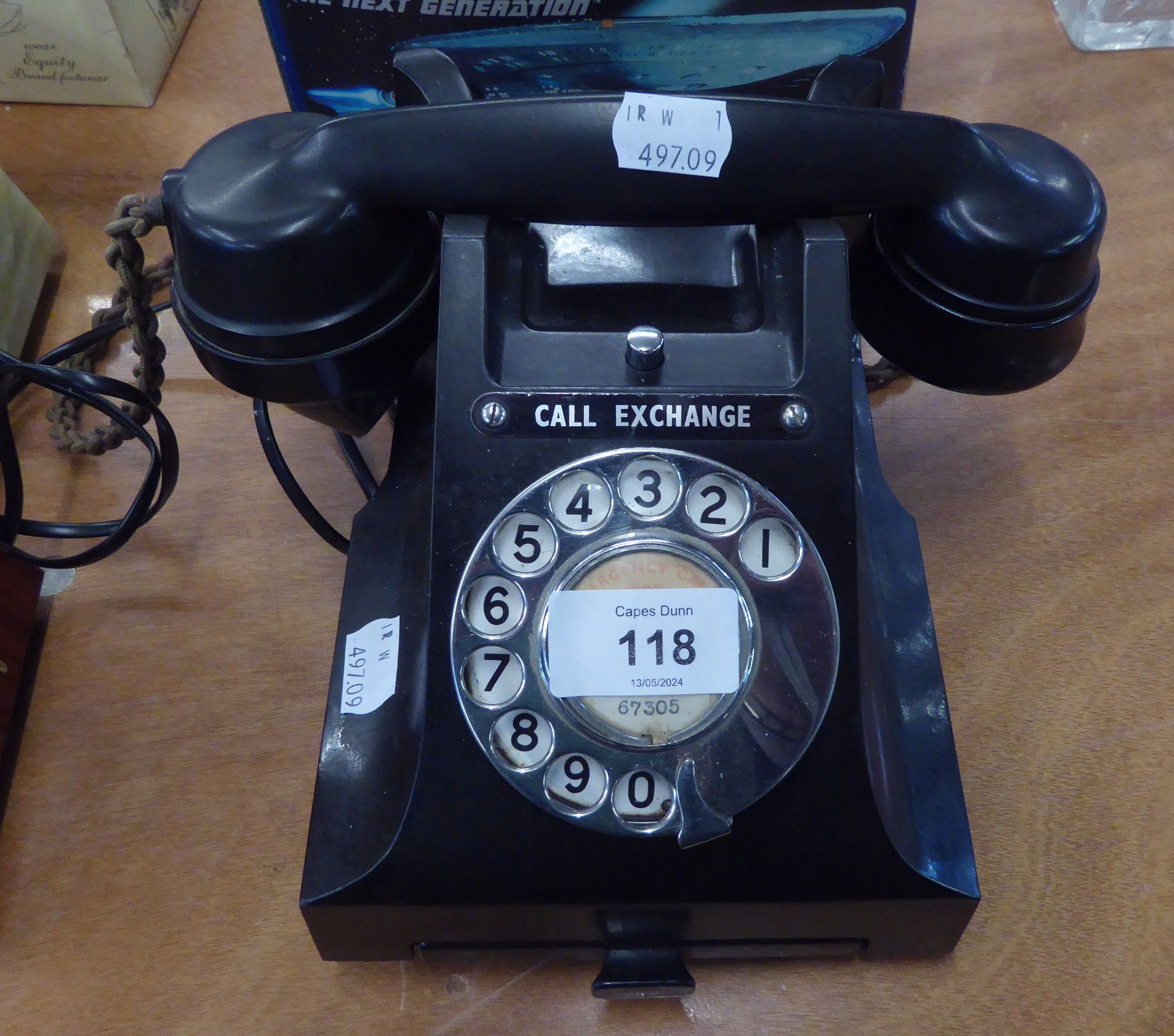 A VINTAGE BLACK TELEPHONE WITH ROTARY DIAL AND TRAY UNDER (CONVERTED FOR USE)