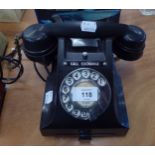 A VINTAGE BLACK TELEPHONE WITH ROTARY DIAL AND TRAY UNDER (CONVERTED FOR USE)
