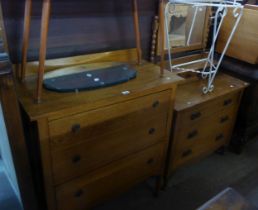 AN OAK CHEST OF THREE DRAWERS AND A SINGLE THREE DRAWER DRESSING TABLE, WITH SWING MIRROR