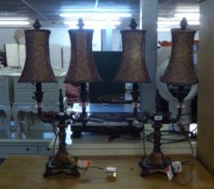 PAIR OF BLACK AND GILT METAL AND GLASS ELECTRIC TWO LIGHT CANDELABRA, AS BEDSIDE LAMPS WITH SHADES