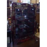 A SMALL ORIENTAL LACQUERED WALL HANGING DISPLAY CABINET WITH BIRD AND FLOWER DECORATION