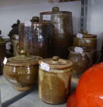 'THE FRIARS', AYLESFORD FOUR GRADUATED HAND MADE STONEWARE KITCHEN STORAGE JARS AND COVERS IN A
