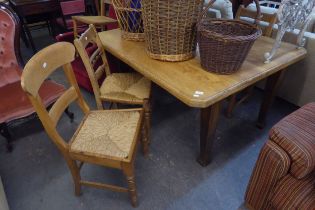 AN OAK FRAMED VICTORIAN DINING TABLE, WITH REPLACEMENT PINE TOP, THREE LADDER-BACK DINING CHAIRS,