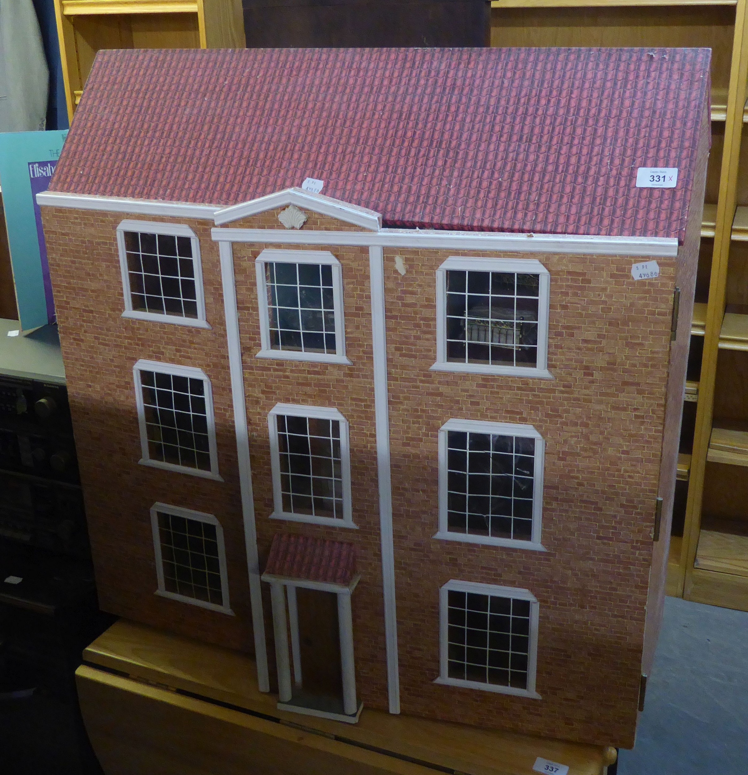 A THREE STOREY DOLLS HOUSE, HAVING TWO FULLY OPENING FRONT DOORS, AND A SELECTION OF DOLLS HOUSE