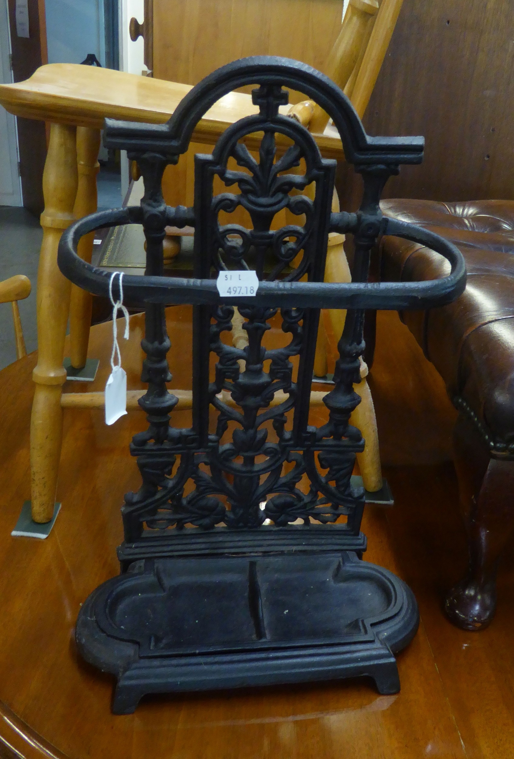 A VICTORIAN CAST IRON ORNATE STICK STAND AND A WROUGHT IRON STANDARD LAMP (2)