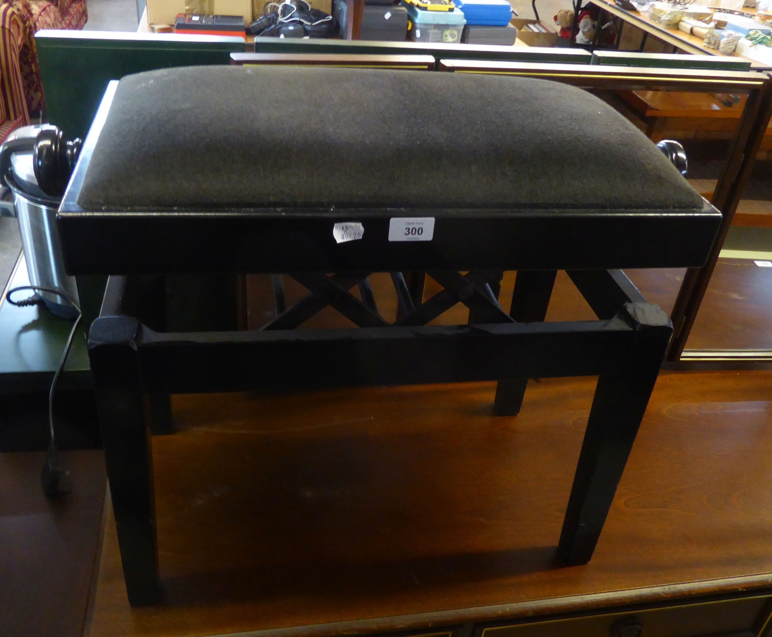 A BLACK LACQUERED OBLONG PIANO STOOL, ADJUSTABLE FOR HEIGHT