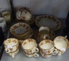 A WILD BROS. FLORAL PATTERN CHINA TEA SERVICE FOR 12 PERSONS WITH MILK JUG AND SUGAR BOWL (A.F.)