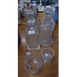 THREE CUT GLASS DECANTERS, A MOULDED GLASS DECANTER AND A SMALL CUT GLASS TEALIGHT HOLDER (5)