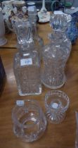 THREE CUT GLASS DECANTERS, A MOULDED GLASS DECANTER AND A SMALL CUT GLASS TEALIGHT HOLDER (5)
