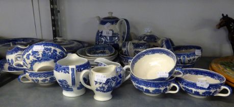 A QUANTITY OF WILLOW PATTERN BLUE AND WHITE DINNER AND TEA WARES, TO INCLUDE; CUPS, MILK JUGS,
