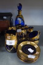 SIX VENETIAN BLUE AND GILT GLASS COFFEE CUPS AND SAUCERS, WITH CERAMIC FLOWERS APPLIED, CREAM JUG,