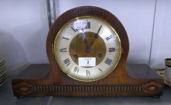 AN OAK NAPOLEONS HAT SHAPED MANTEL CLOCK, WITH 8 DAY STRIKING MOVEMENT