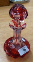 A RUBY FLASHED CUT GLASS GLOBE AND SHAFT SHAPED LIQUEUR DECANTER AND STOPPER