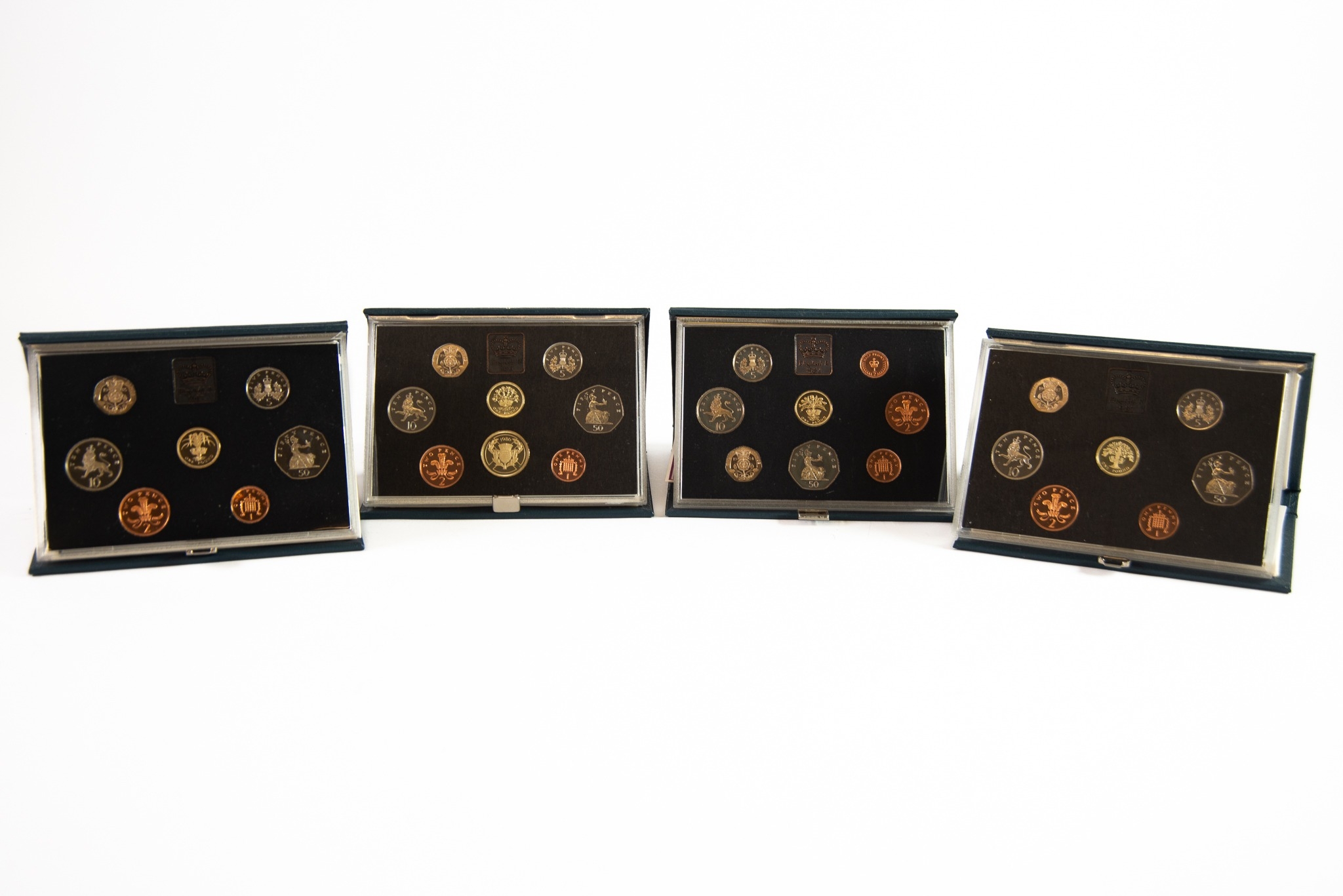 FOUR ROYAL MINT UNITED KINGDOM PROOF COIN SETS, for years 1984, (lacks certificate), 1985, 1986