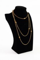 9ct GOLD BELCHER LINK LONG GUARD CHAIN, with seven gold chased bead dividers and watch clip, 56in (