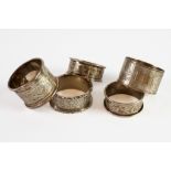 FIVE EDWARD VII AND LATER SILVER NAPKIN RINGS, including an ivy leaf engraved pair, 2.30ozt, (5)