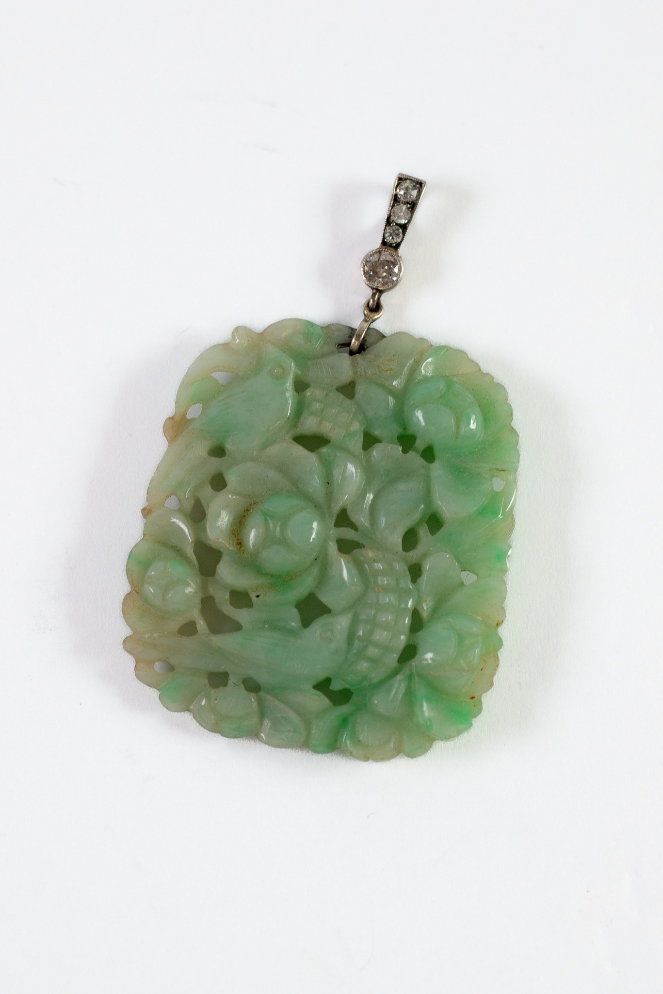 GOOD CHINESE CARVED GREEN JADE PENDANT, PIERCED and on each side with TWO BIRDS EATING FRUIT amongst