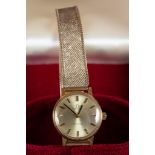 LADY'S OMEGA WRIST WATCH with gold-plated case, circular silvered dial with batons and 9ct gold