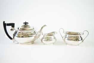 GEORGE VI THREE PIECE SILVER TEASET, of rounded oblong form with black angular scroll handle and
