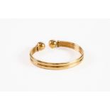 9ct GOLD TWO-STRAND HOLLOW TORQUE BANGLE, with ball terminals, 7.8gms