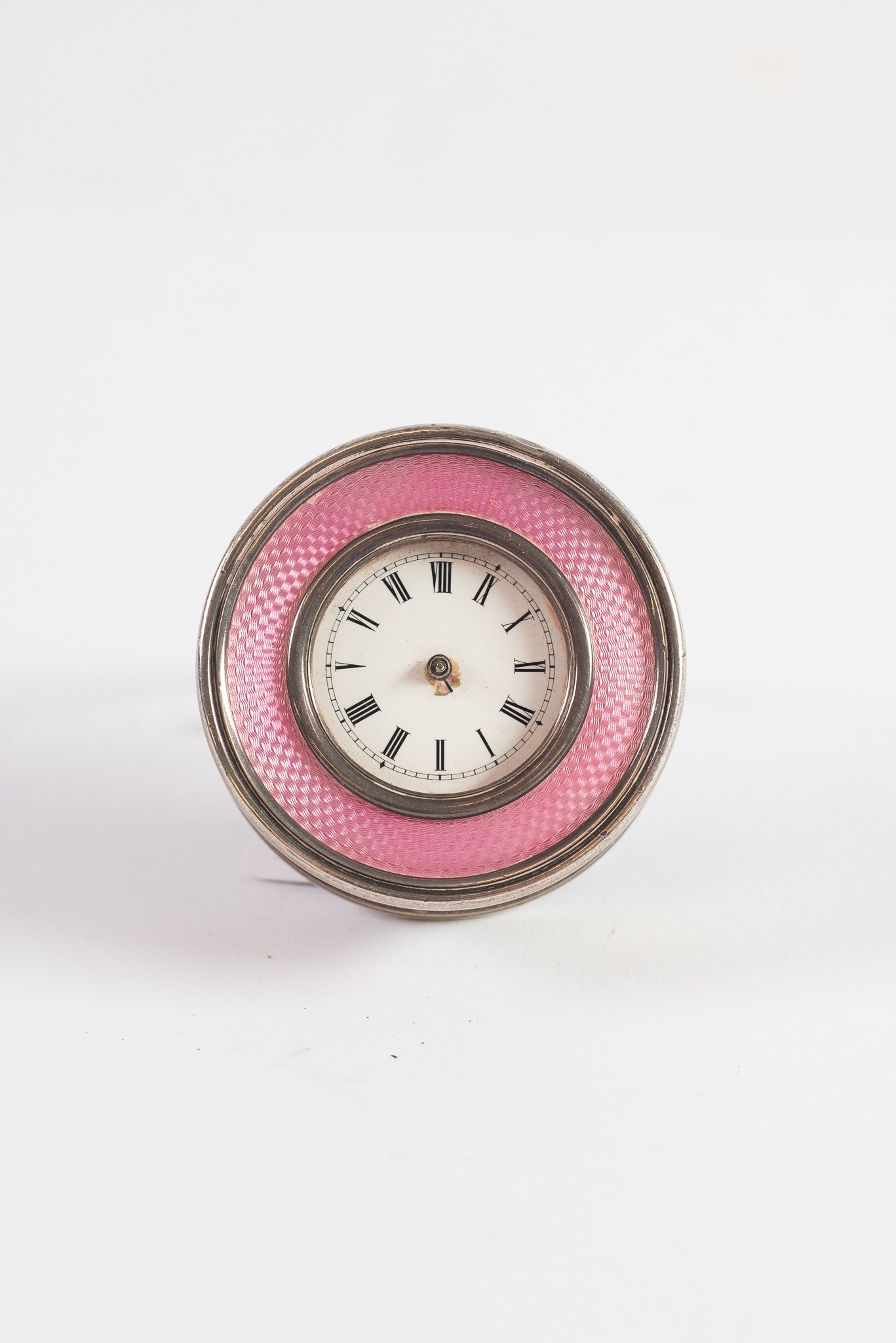 EDWARDIAN SILVER AND PINK GUILLOCHE ENAMEL CIRCULAR BEDSIDE TIMEPIECE, with SWISS MADE movement,