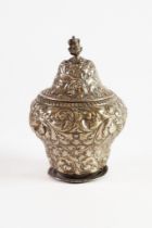 VICTORIAN EMBOSSED SILVER TEA CADDY AND COVER, of footed baluster form with foliate scroll cast knop