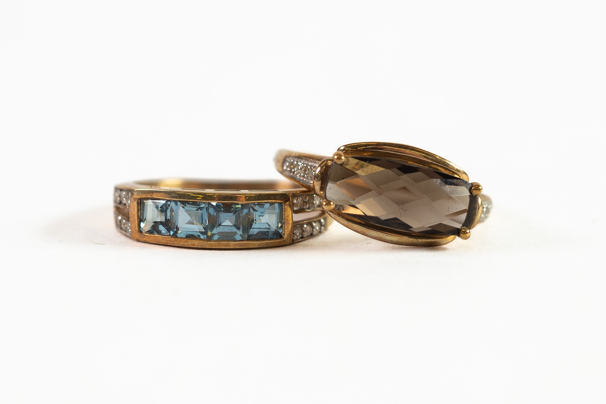 9ct GOLD RING WITH OVAL SMOKEY QUARTZ set east to west with tiny diamonds to the shoulders; 9ct