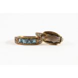 9ct GOLD RING WITH OVAL SMOKEY QUARTZ set east to west with tiny diamonds to the shoulders; 9ct