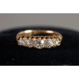 18ct GOLD RING with five old cut round diamonds in a lozenge shaped setting, the centre stone