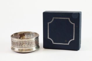 MODERN PIERCED SILVER WINE COASTER, of typical form with turned mahogany base, 3 ¾” (9.5cm)