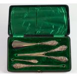 EDWARD VII CASED FOUR PIECE TRAVELLING SET WITH FILLED SILVER HANDLES, comprising; TWO BUTTON HOOKS,