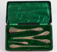 EDWARD VII CASED FOUR PIECE TRAVELLING SET WITH FILLED SILVER HANDLES, comprising; TWO BUTTON HOOKS,