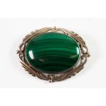 LARGE SILVER FRAME CABOCHON OVAL MALACHITE BROOCH, with foliated scroll surround, 2 1/4in (5.5cm)