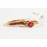 9ct GOLD RING set with a tear shaped ruby and a tiny white stone to each shoulder; and a 9ct GOLD