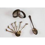 PAIR OF ENGINE TURNED SILVER OVAL NAPKIN RINGS, indistinct date mark together with a SILVER TEASPOON