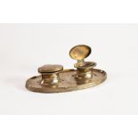 WEIGHTED PLAIN SILVER PRESENTATION DOUBLE INKWELL, of oval form with moulded base and clear glass