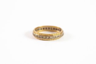 18ct YELLOW AND WHITE GOLD FACETED ETERNITY RING set with tiny white stones, 4.8gms,