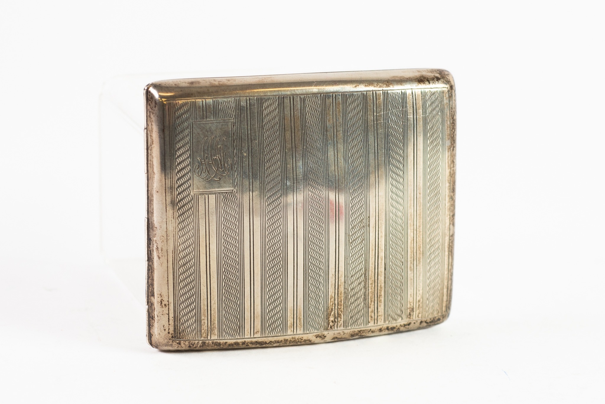 SILVER POCKET CIGARETTE CASE, curved oblong and cushion shaped with striped engine turned