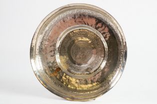 PERSIAN PLANISHED SILVER COLOURED METAL FOOTED DISH, decorated with bands of stylised motifs and