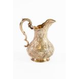 VICTORIAN EMBOSSED SILVER MILK JUG BY MARTIN, HALL & Co, of footed baluster form with fancy double