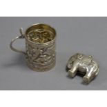 UNMARKED INDIAN EMBOSSED SILVER COLOURED METAL MINIATURE TANKARD, with cobra pattern handle,