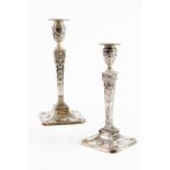 PAIR OF VICTORIAN EMBOSSED AND WEIGHTED SILVER CANDLESTICKS, each of square, tapering form with