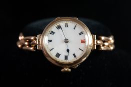 LADY'S EDWARDIAN 9ct GOLD WRIST WATCH with mechanical movement, circular white porcelain roman dial,