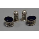 FOUR PIECE PIERCED SILVER CONDIMENT SET, comprising: PAIR OF PEPPERETTES and a PAIR OF OVAL OPEN