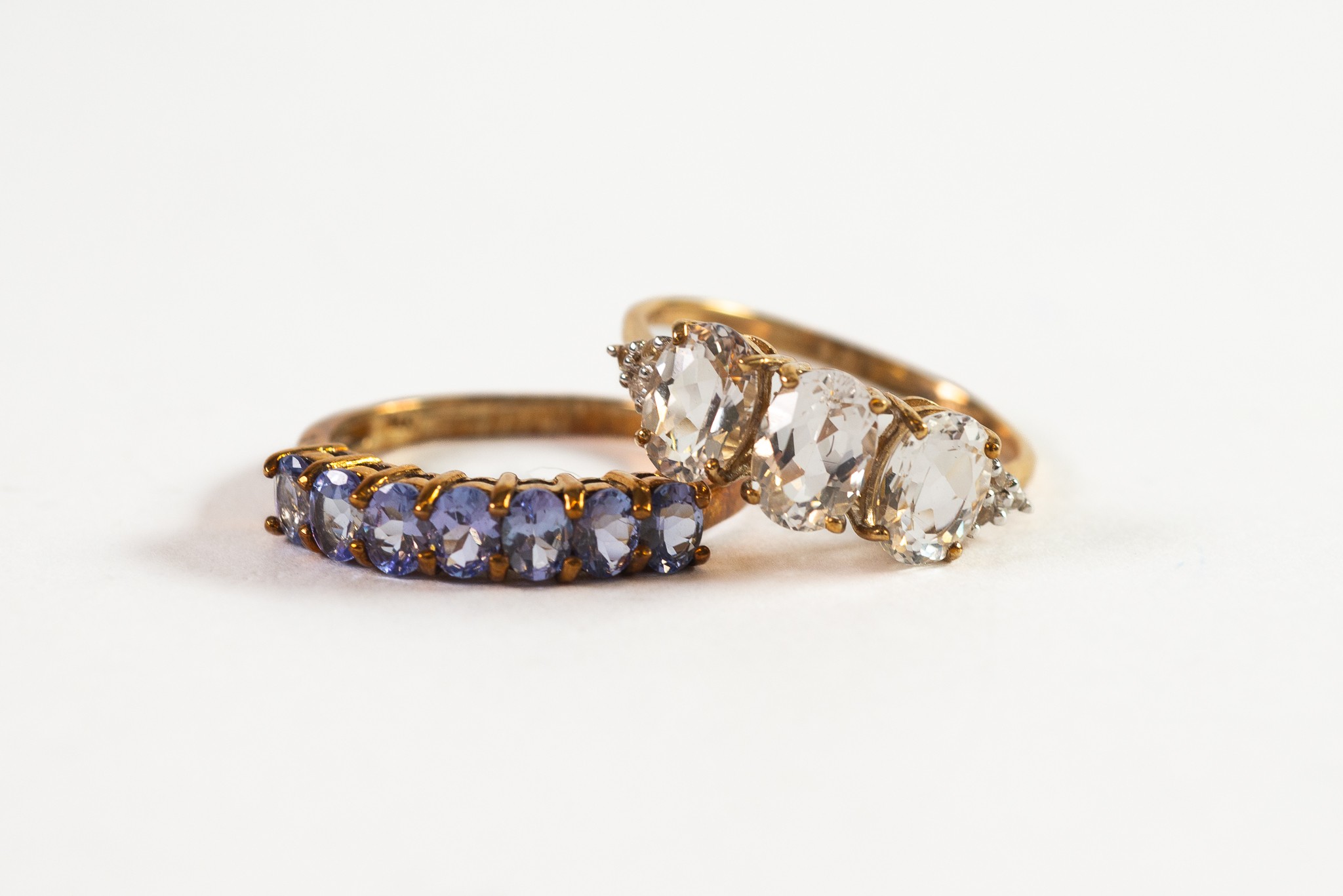 9ct GOLD RING set with a row of seven uniform tanzanite; and 9ct GOLD RING set with a row of three