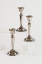 SET OF THREE WEIGHTED SILVER DRESSING TABLE CANDLESTICKS, each of tapering form with beaded border