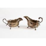 TWO PLAIN SILVER SAUCE BOATS, one VICTORIAN, with leaf capped flying scroll handle, cyma border